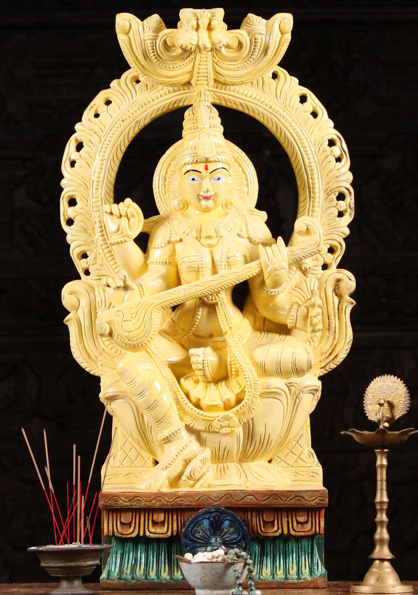 Wooden Yellow Saraswati Playing Veena Seated Beneath Mahakala Arch 30"