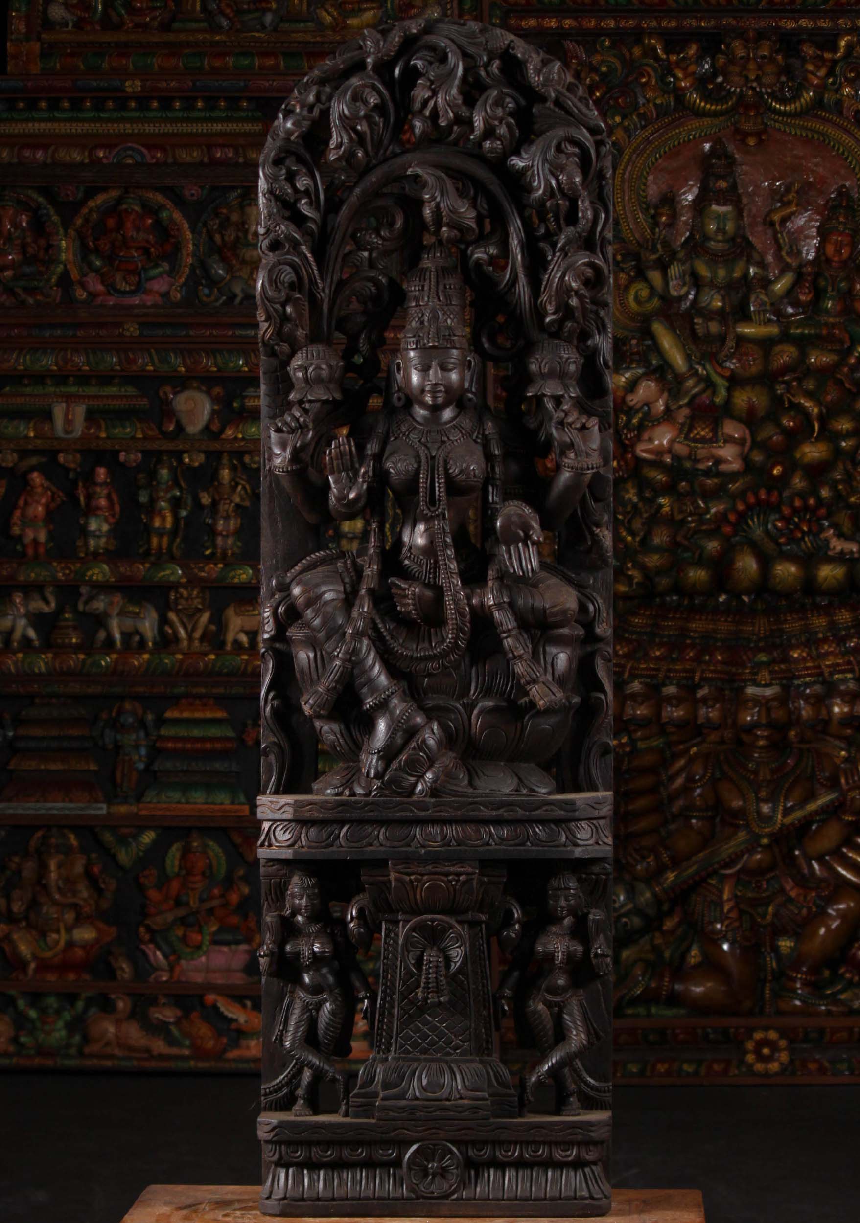 Wood Seated Lakshmi Beneath Lush Canopy 60"