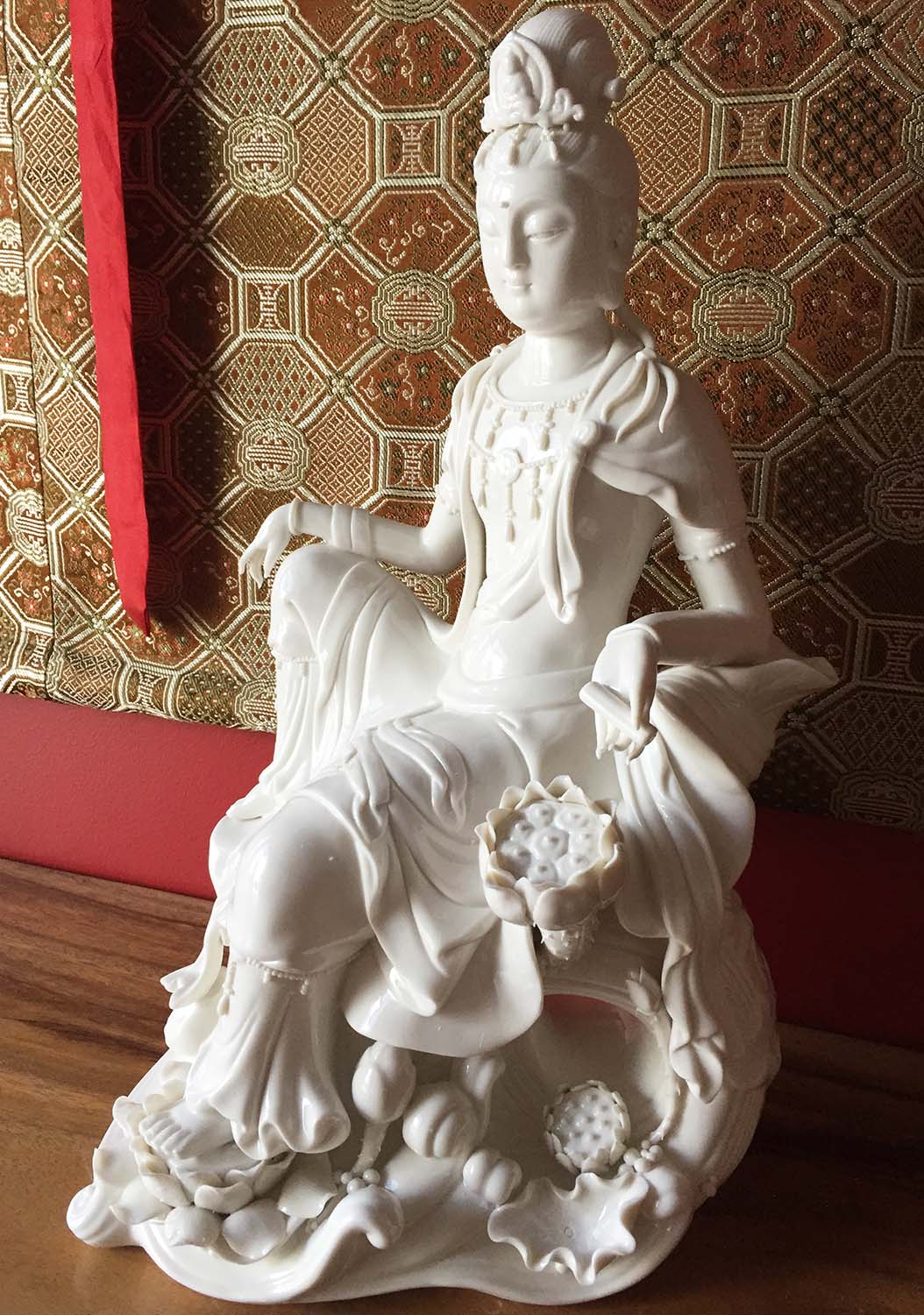 Porcelain Avalokiteshvara Statue Seated in a Relaxed Position on an Ocean of Waves on Lilys 16"