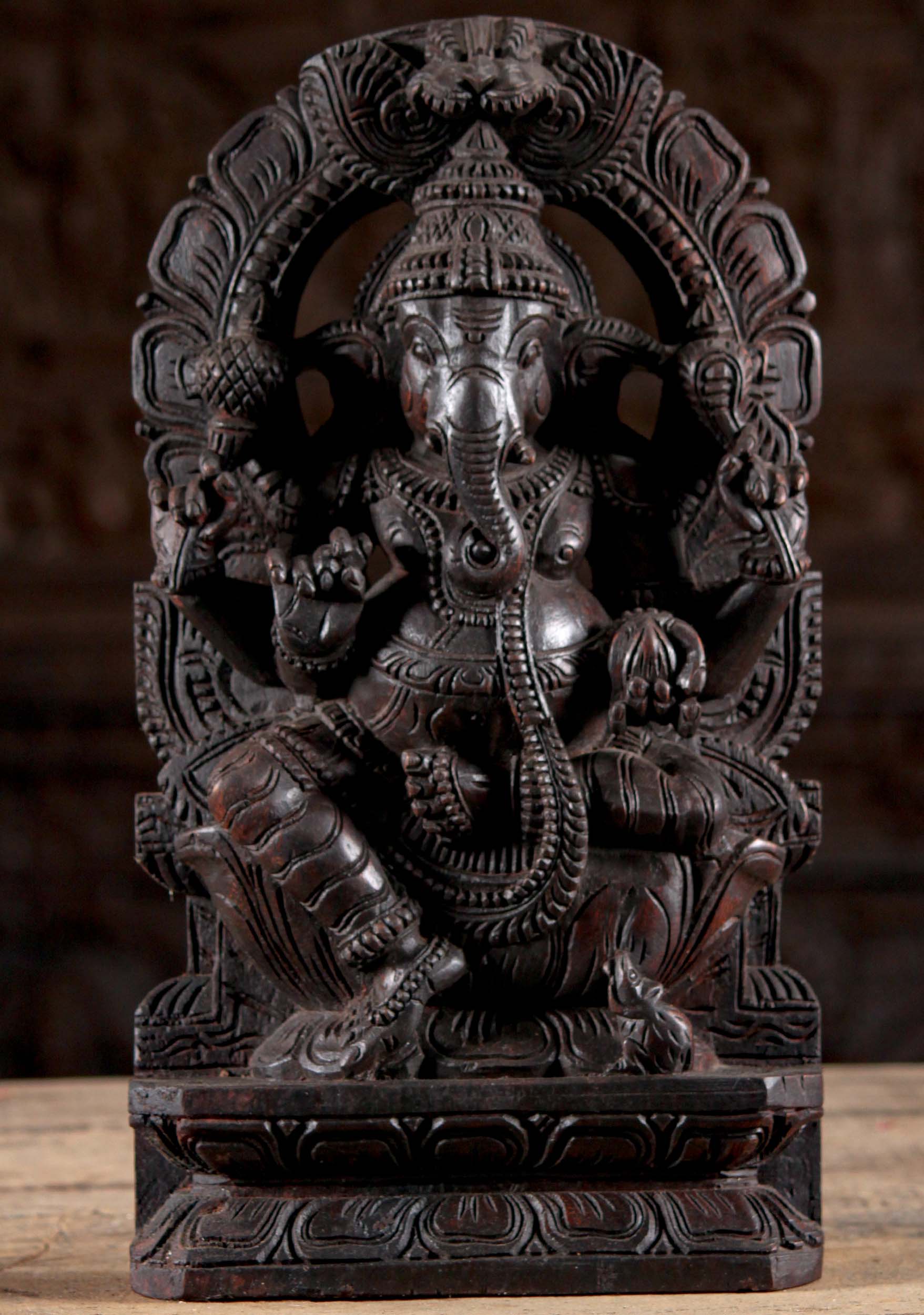 Wood Ganesh Seated Under Arch Holding Tusk 18"