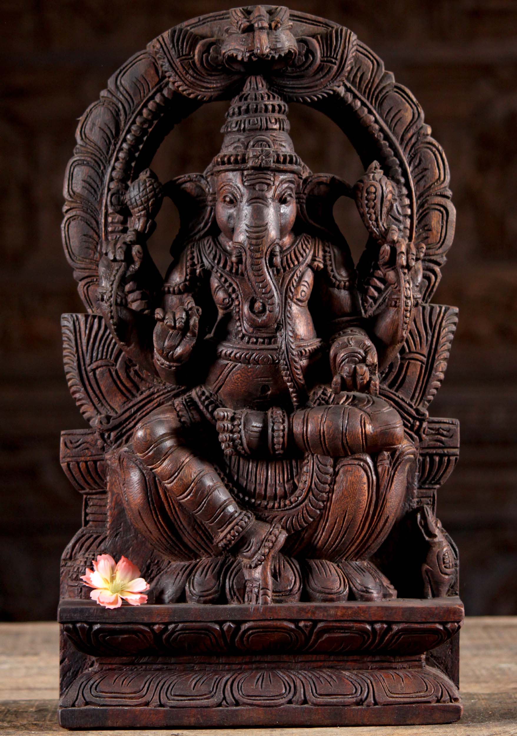 Wood Ganesh Seated Under Arch Holding Tusk 18"