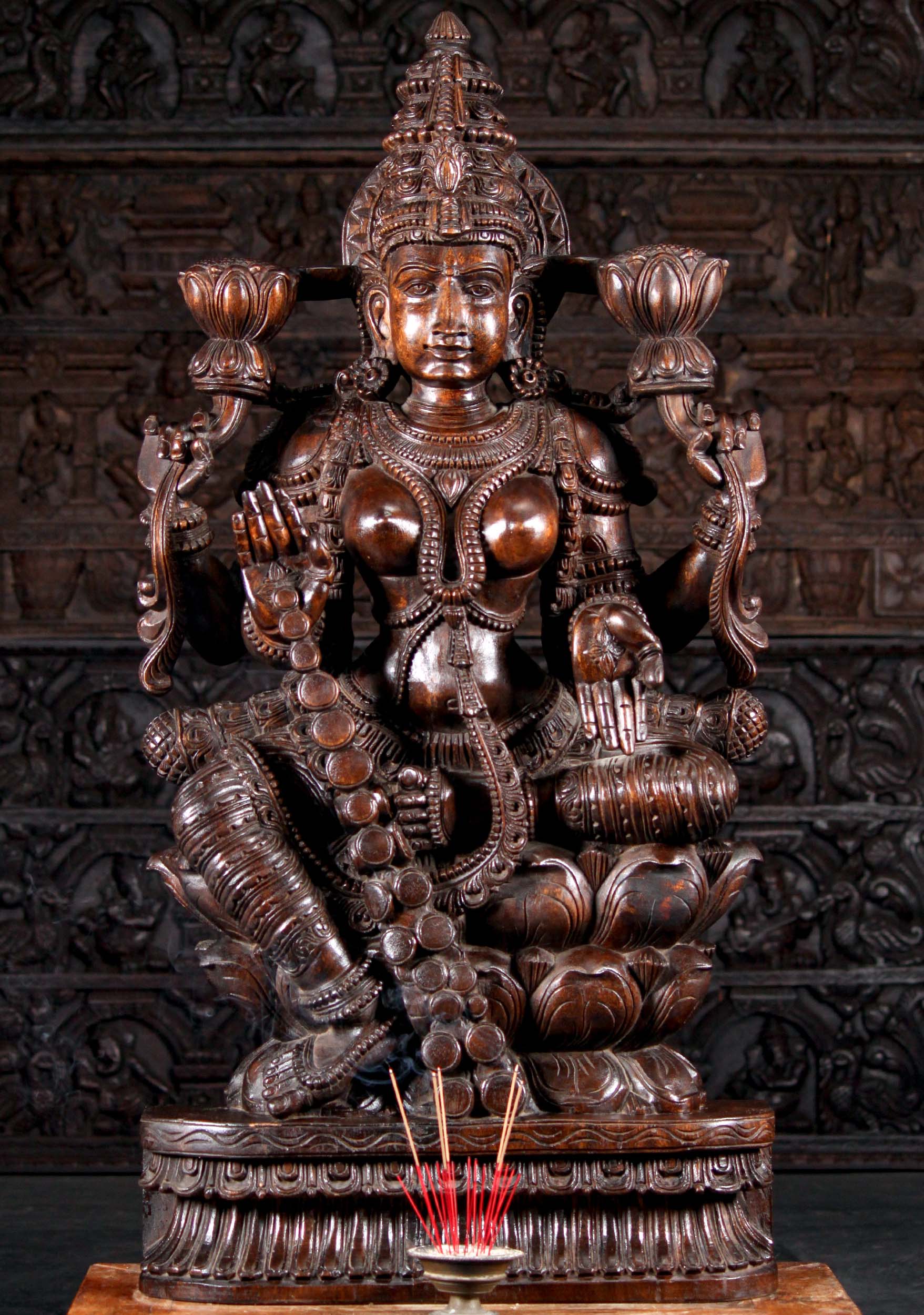 Dark Wood Seated Lakshmi Sculpture Holding Two Lotus Flowers Granting Boons with Coins 48"