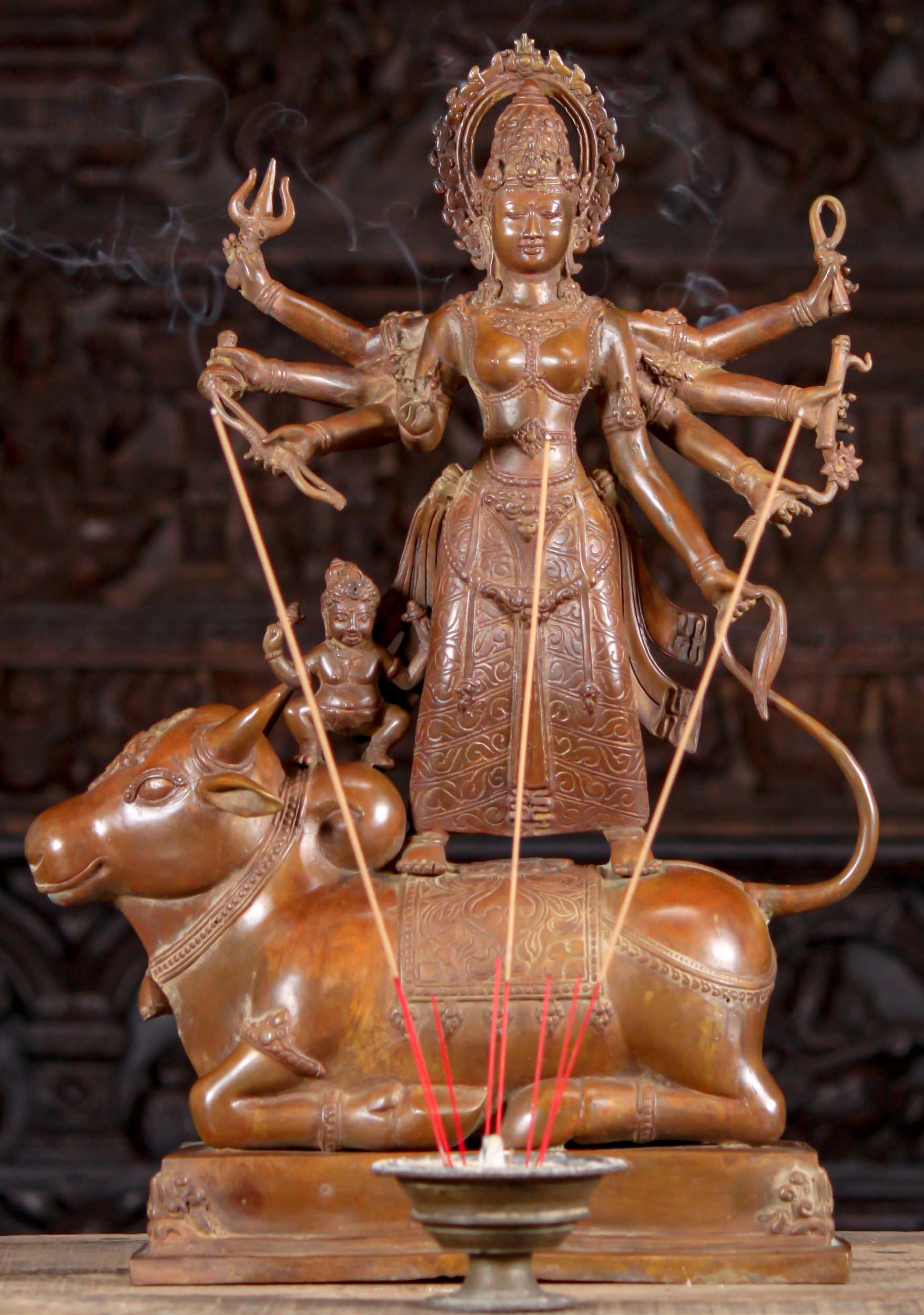 https://www.lotussculpture.com/mm5/graphics/00000001/49/1-copper-colored-brass-durga-statue-on-bull-with-8-arms-sculpture-c.jpg