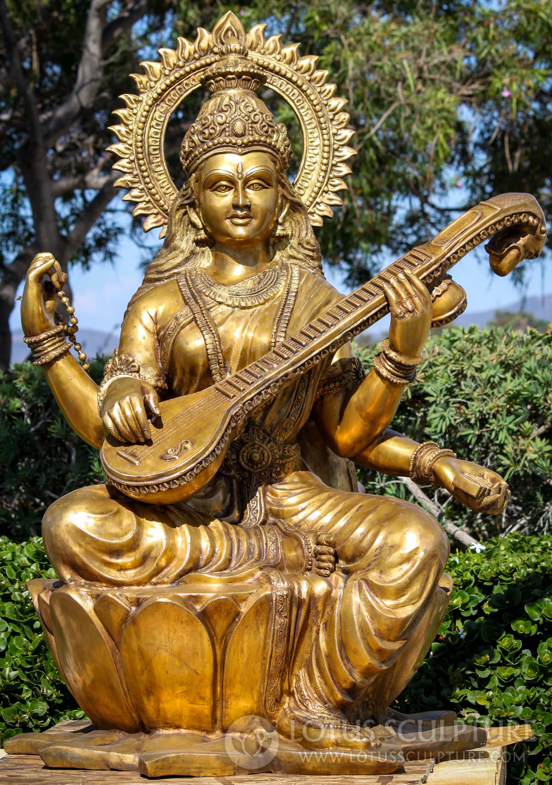 https://www.lotussculpture.com/mm5/graphics/00000001/50/1-large-golden-brass-hindu-goddess-of-wisdom-saraswati-statue-with-veena-on-lotus-flower-c.jpg